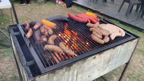 Barbecue on grill severals, black pudding, blood sausage, sausages,corn Stock Footage 322091432