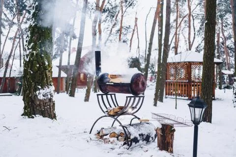 Barbecue grill in the snow-covered complex in smoke Stock Photos