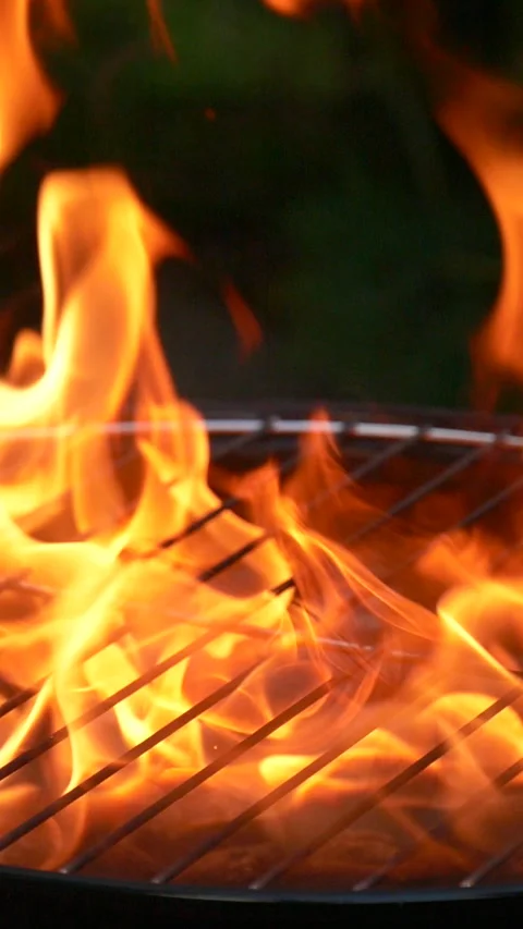 Barbecue grill, vertical slow motion burning fire flame, bbq picnic in backyard Stock Footage 266772777