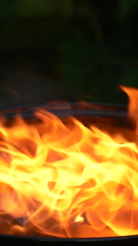 Barbecue grill, vertical slow motion burning fire flame, bbq picnic in backyard Stock Footage 275010055