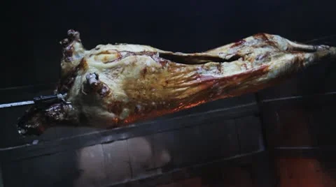 Barbecue lamb over hot wooden fire. Rotisserie Spit BBQ Whole Lambs At A Outdoor Stock Footage
