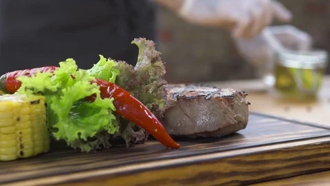 Barbecue meat steak composition. Grilled steak with red hot pepper, herb, corn Video stock 104463150