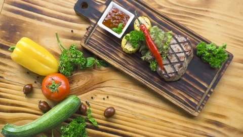 Barbecue meat steak composition top view. Grilled steak with red hot pepper Stock Footage 104463310