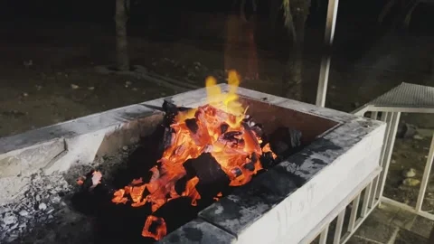 Barbecue pit with blazing charcoal fire and sparks Stock Footage 345145042
