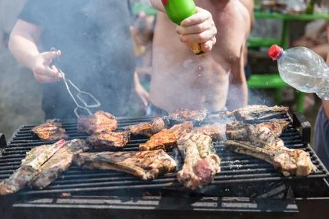 Barbecue, process of cooking meat. Rest on weekends. Friends on picnic Fotos Stock