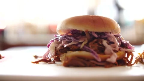 Barbecue pulled pork sandwich being dropped in slow motion ready to eat Stock Footage 207923773