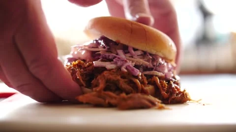 Barbecue pulled pork sandwich overstuffed sandwich being picked up slow motion Stock Footage 207923641