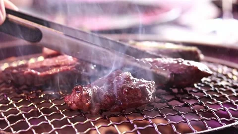 Barbecue in a restaurant, roasting meat at the table. Cooking  Stock Footage 203477558
