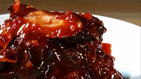Barbecue sauce dripping over a stack of cooked ribs Stock Footage 327514321