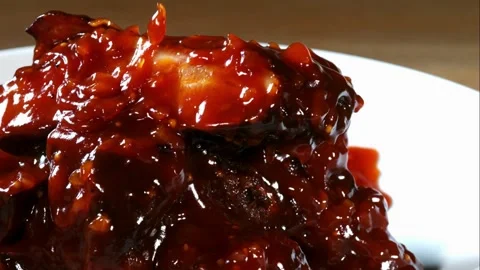 Barbecue sauce pouring over a stack of ribs Stock Footage 327632351