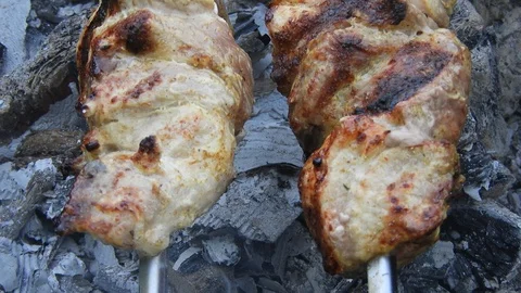 Barbecue on skewers close up on the fire Stock Footage 128983403