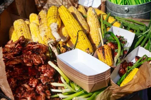 Barbecue spread corn on the cob, steak fillet and chicken kebabs with corn. Stock Photos