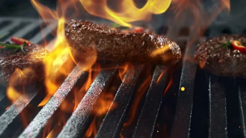 Barbecued Beef Burger Patty Falling onto Smoking and Flaming Grill Grate 스톡 동영상 146410814