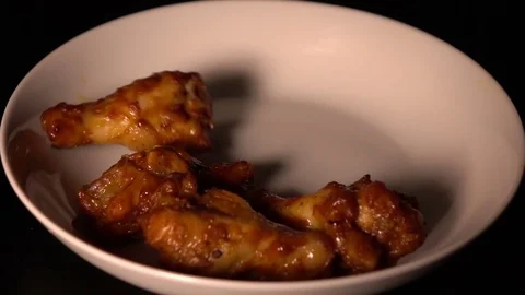 Barbecued chicken falling on the plate Stock Footage 74279632