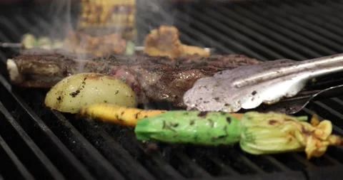 Barbecued meat and vegetables Stock Footage 142557417
