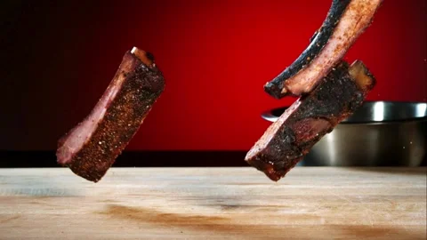 Barbecued pork ribs falling and stacking on wooden board Stock Footage 327577366
