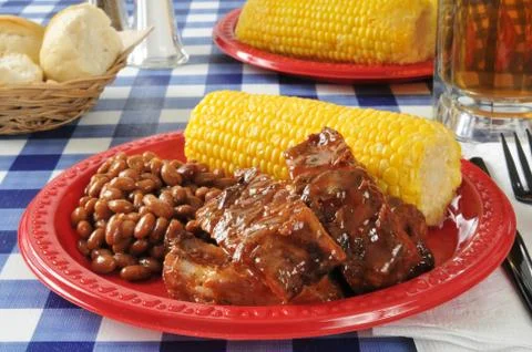 Barbecued ribs with corn on the cob Stock Photos