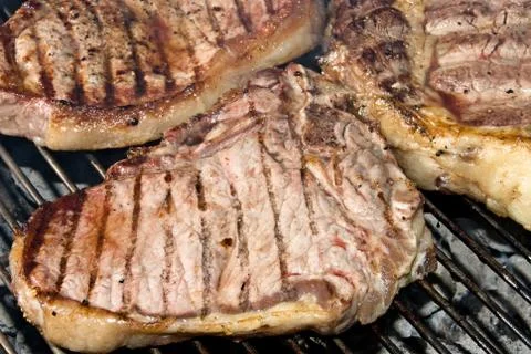 Barbecued steaks Stock Photos