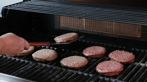 Barbecuing plant based Impossible Burger patties on electric grill semi close up Stock Footage 249716566