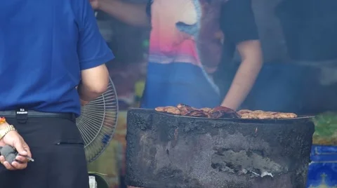 Barbecuing pork on a grill Stock Footage 52909402