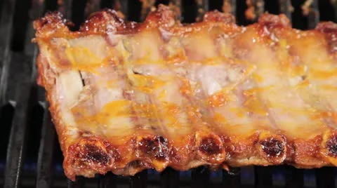 Barbecuing spareribs Stock Footage 24656611