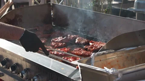 Barbecuing Steaks and Flipping Them on the Grill Stock Footage 321647437