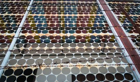 Barbed fire on a wall Stock Photos