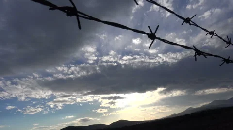 Barbed Wire against the Cloudy Sky  Видео 59777111