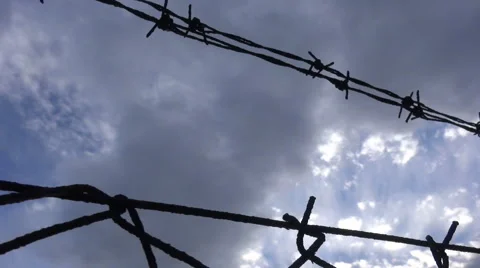 Barbed Wire against the Cloudy Sky  Stock Footage 59777161