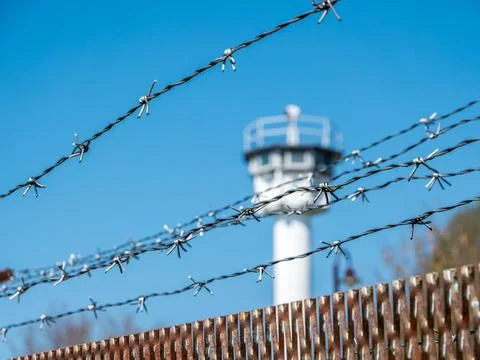 Barbed Wire and GDR Border Watchtower  Cold War History Stock Photos