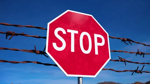 Barbed Wire and Stop Sign Stockbeeldmateriaal 314016688