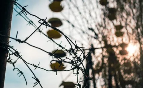 Barbed wire on the background of a carousel in an amusement park in Chernobyl Stock Photos