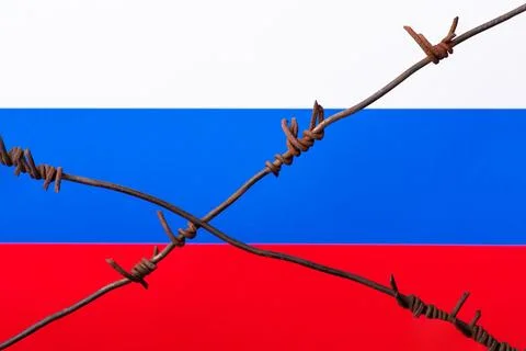 Barbed wire on the background of Russian flag Stock Photos
