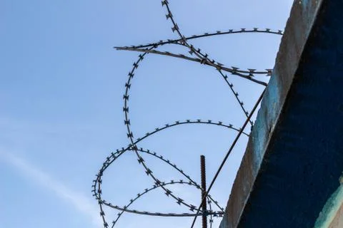 Barbed wire on blue sky background Stock Photos