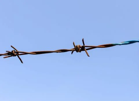 Barbed wire on blue sky background Stock Photos