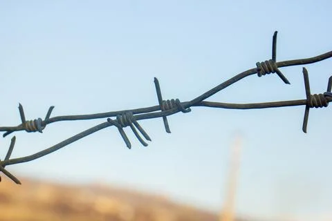 Barbed wire on blue sky background Stock Photos