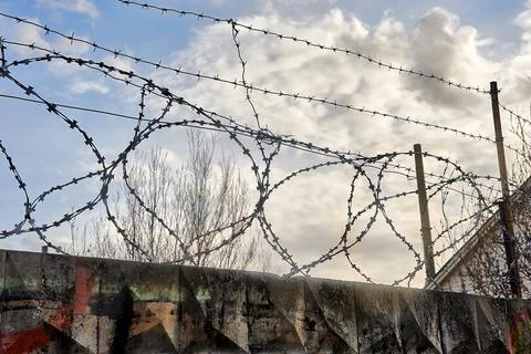 Barbed wire on a blue sky background. Stock Photos