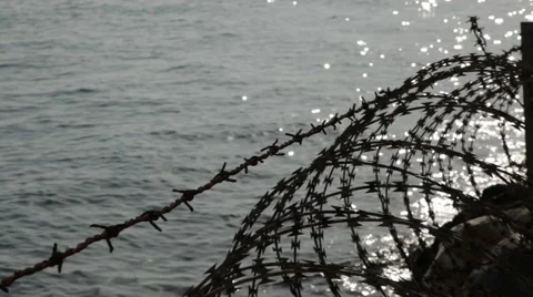 Barbed Wire - Borders, frontiers by the sea. Stock Footage 58604773