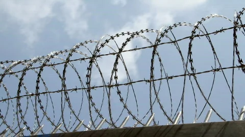 Barbed wire fence with cloud sky Stock Footage