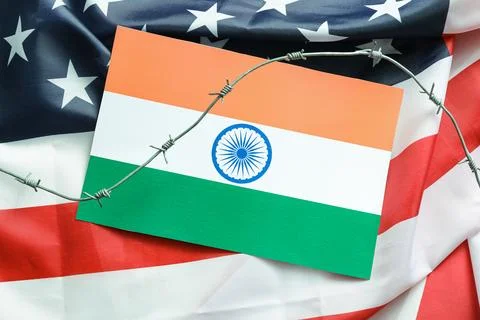 Barbed wire on flags of India and USA. Sanctions concept Stock Photos