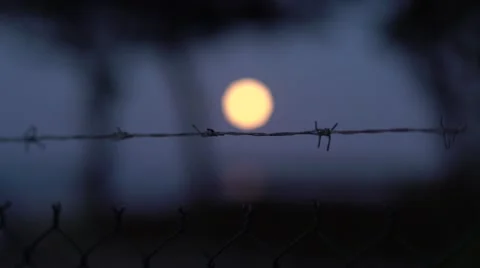 Barbed Wire to Full Moon Focus 4K Stock Footage 67397333