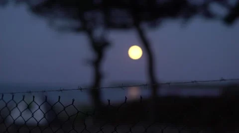 Barbed Wire to Full Moon with Tent Focus 4K Stock Footage 67397317