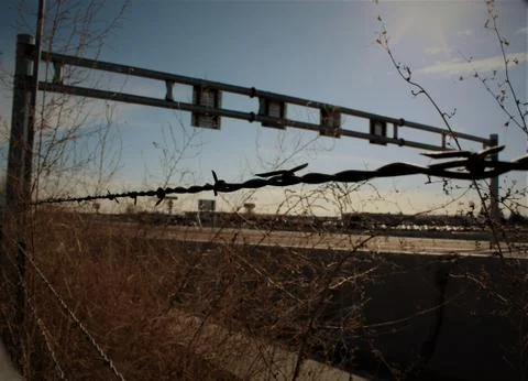 Barbed Wire Next to Freeway Stock Photos