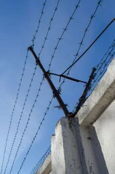 Barbed wire over the wall Stock Photos