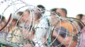 Barbed wire with people on background HD Footage