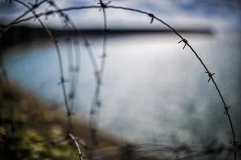 Barbed wire, Pointe du Hoc, Normandy Pointe du Hoc is a promontory with a Stock Photos