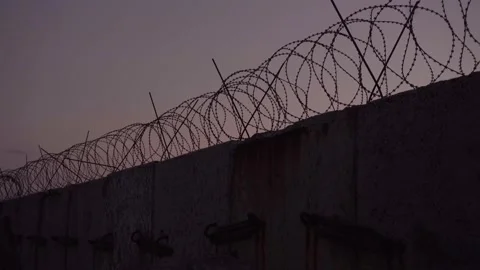 Barbed wire prison wall. sunset. panorama. Stock Footage 160422223