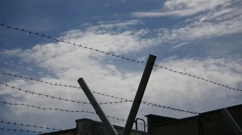 Barbed wire of protected territory - clouds time lapse Stock Footage 50752395