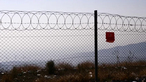 Barbed wire scenery with wind and a lot of rubbish around Stock Footage 119795606