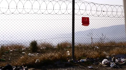 Barbed wire scenery with wind and a lot of rubbish around Stock Footage 119795683